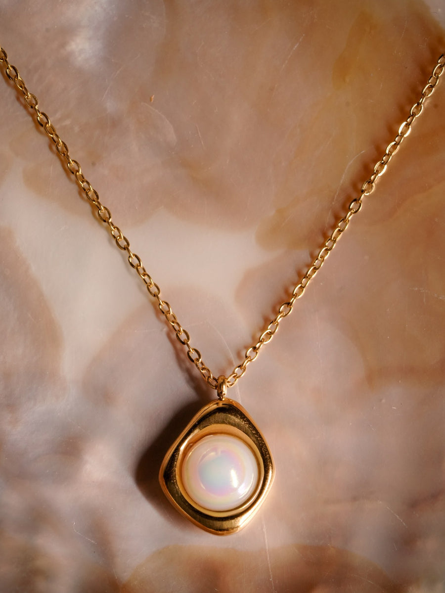 Ashborne Hansika gold-tone freeform pendant with iridescent cabochon, flatlay