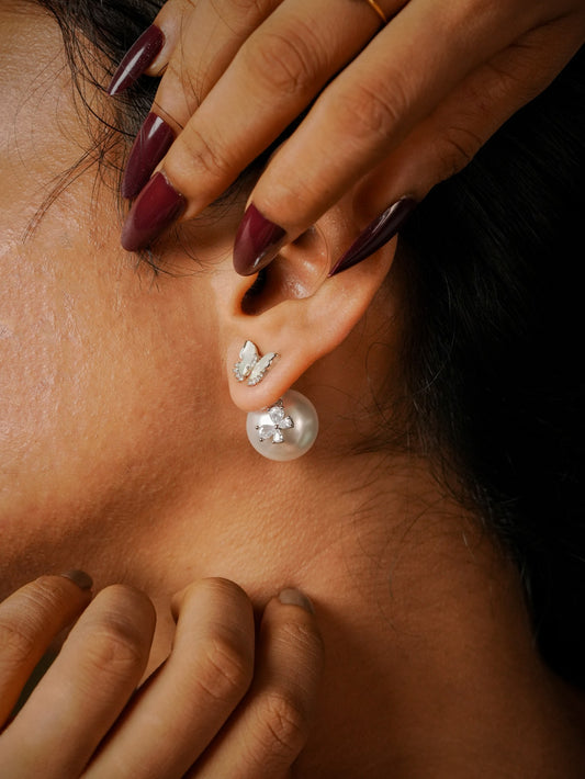 Ashborne Harini butterfly pearl stud worn on the ear with pearl back showing