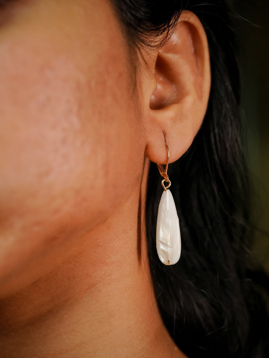Ashborne Jaya mother-of-pearl teardrop drop earring worn on ear