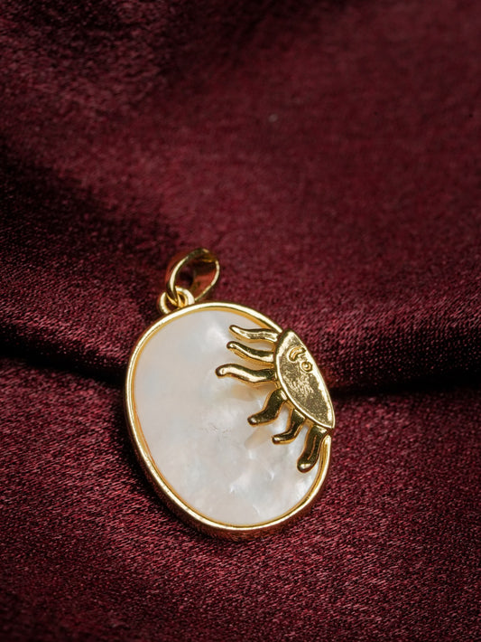 Ashborne Rukmini oval mother-of-pearl pendant with gold sun-face on maroon