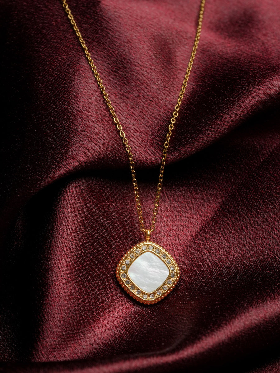 Ashborne Lakshmi cushion pendant, mother-of-pearl centre with crystal pave halo on maroon satin