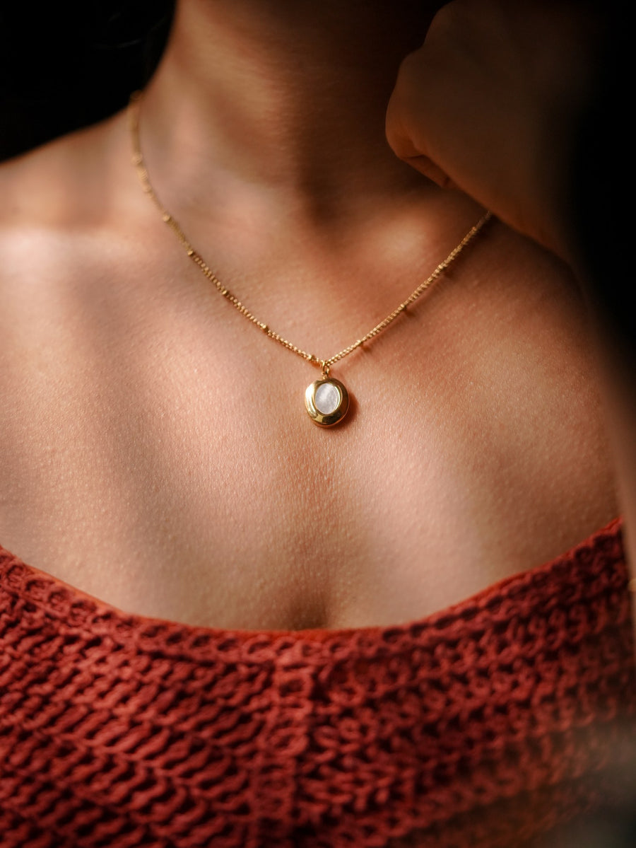 Ashborne Kajal gold-tone round mother-of-pearl pendant on satellite chain, worn
