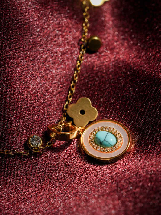Ashborne Deepa evil-eye pendant, turquoise centre with crystal halo and mother-of-pearl ring