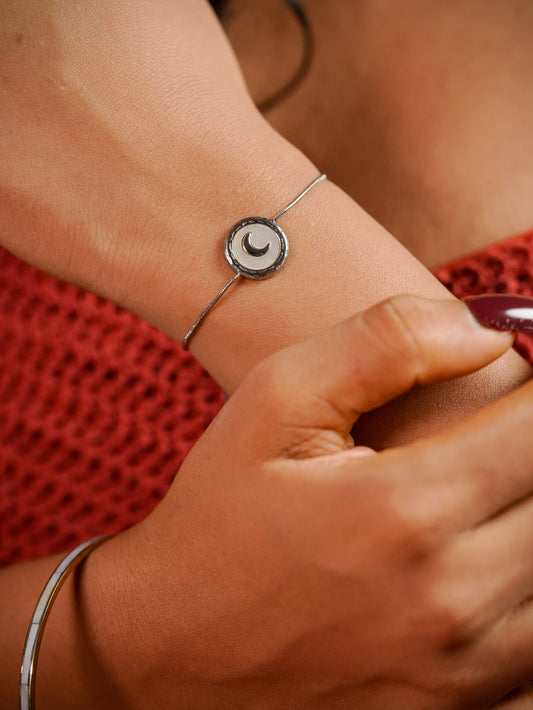 Ashborne Hema crescent-moon mother-of-pearl disc bracelet worn on wrist