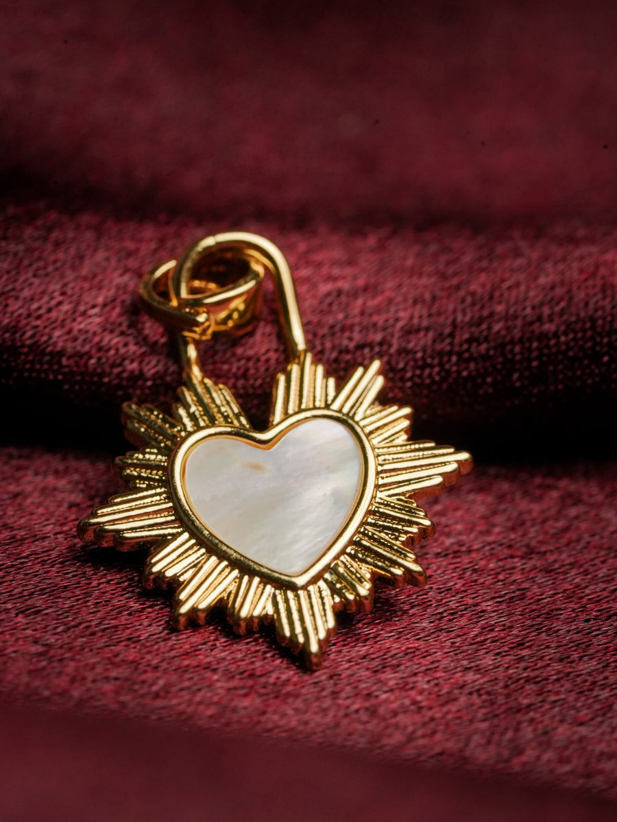 Ashborne Roshni sunburst-frame mother-of-pearl heart pendant on burgundy fabric