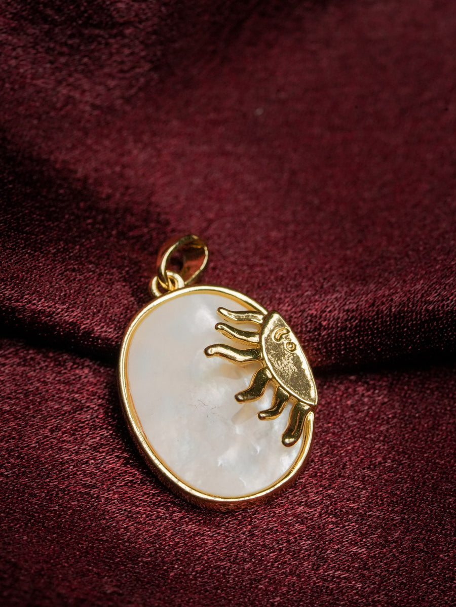 Ashborne Rukmini oval mother-of-pearl pendant with gold sun-face on maroon